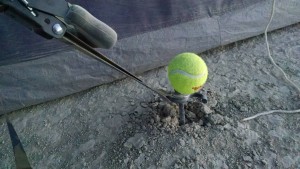 Rebar, washer, and hose clamp. The tennis ball saves your feet.